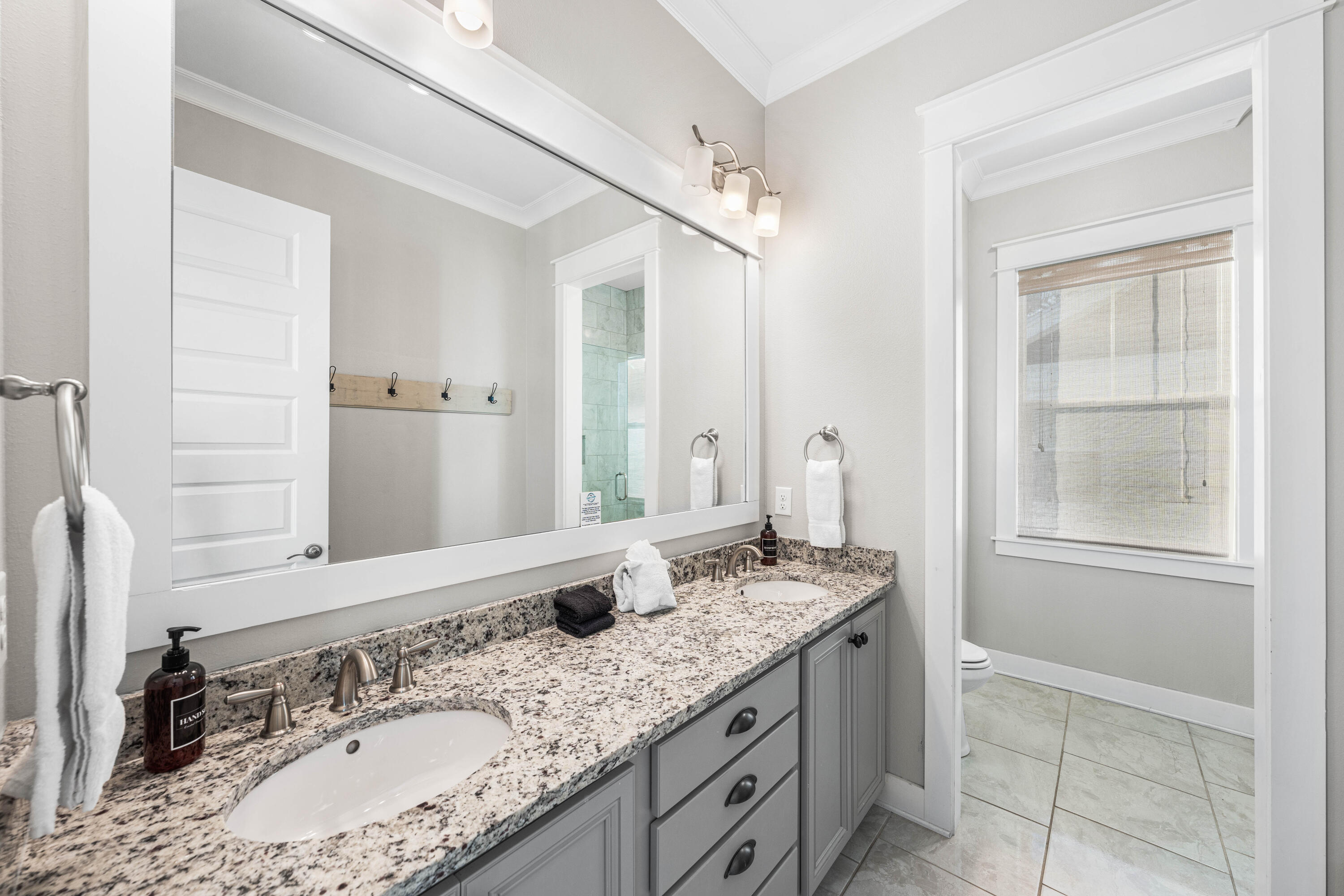 91 Milestone Dr Inlet Beach, Unit B Inlet Beach, FL 32461 - Photo 20 of 51 a bathroom with a granite countertop sink double vanity and a mirror