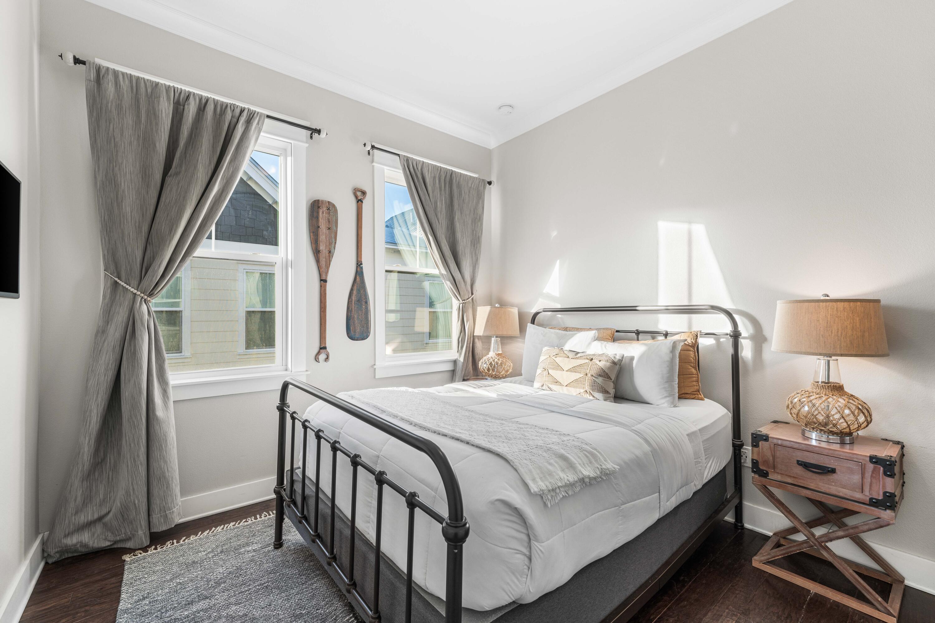 91 Milestone Dr Inlet Beach, Unit B Inlet Beach, FL 32461 - Photo 23 of 51 a bedroom with a bed a mirror and a window