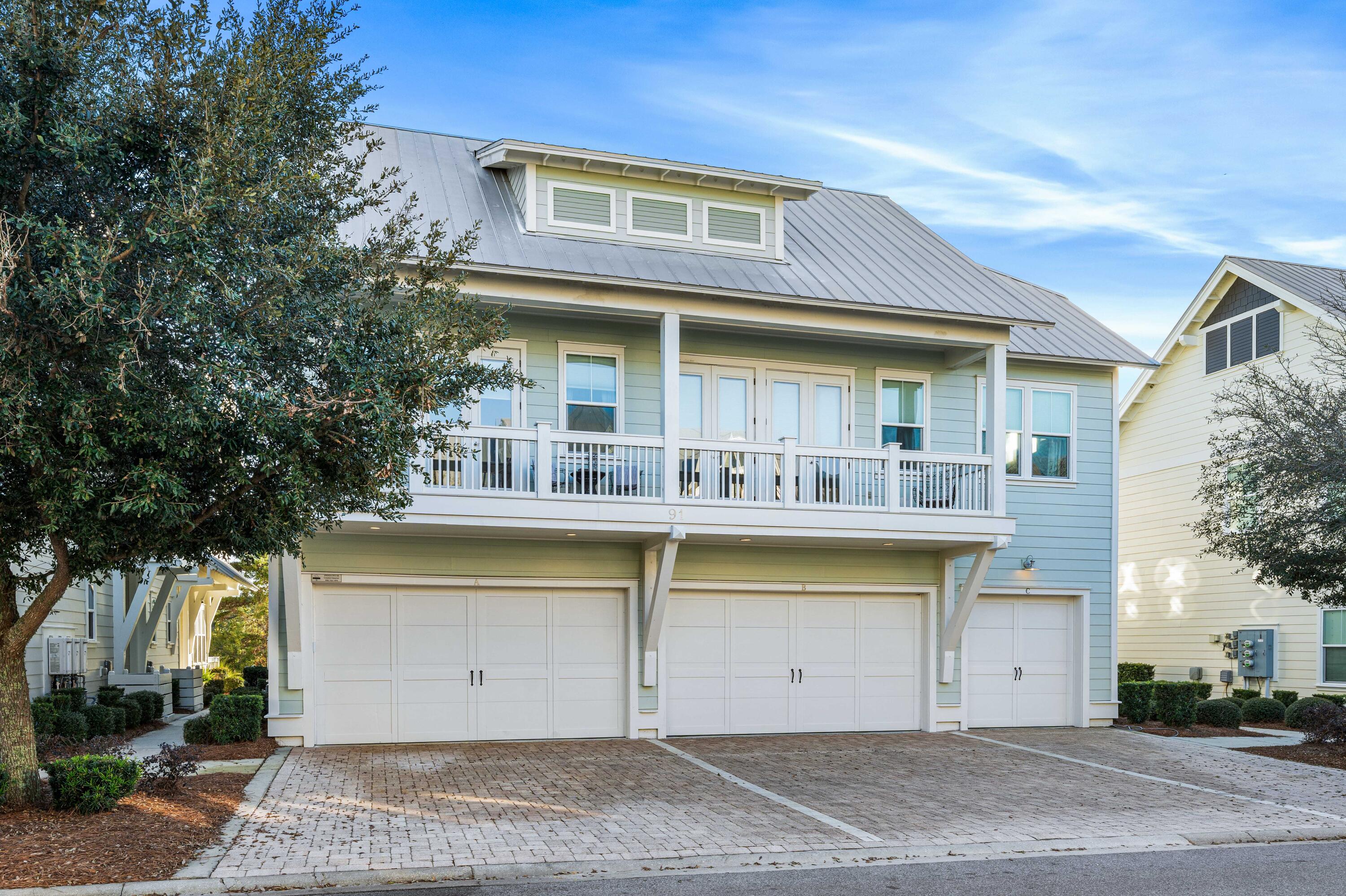 91 Milestone Dr Inlet Beach, Unit B Inlet Beach, FL 32461 - Photo 3 of 51 a front view of a house with a garage