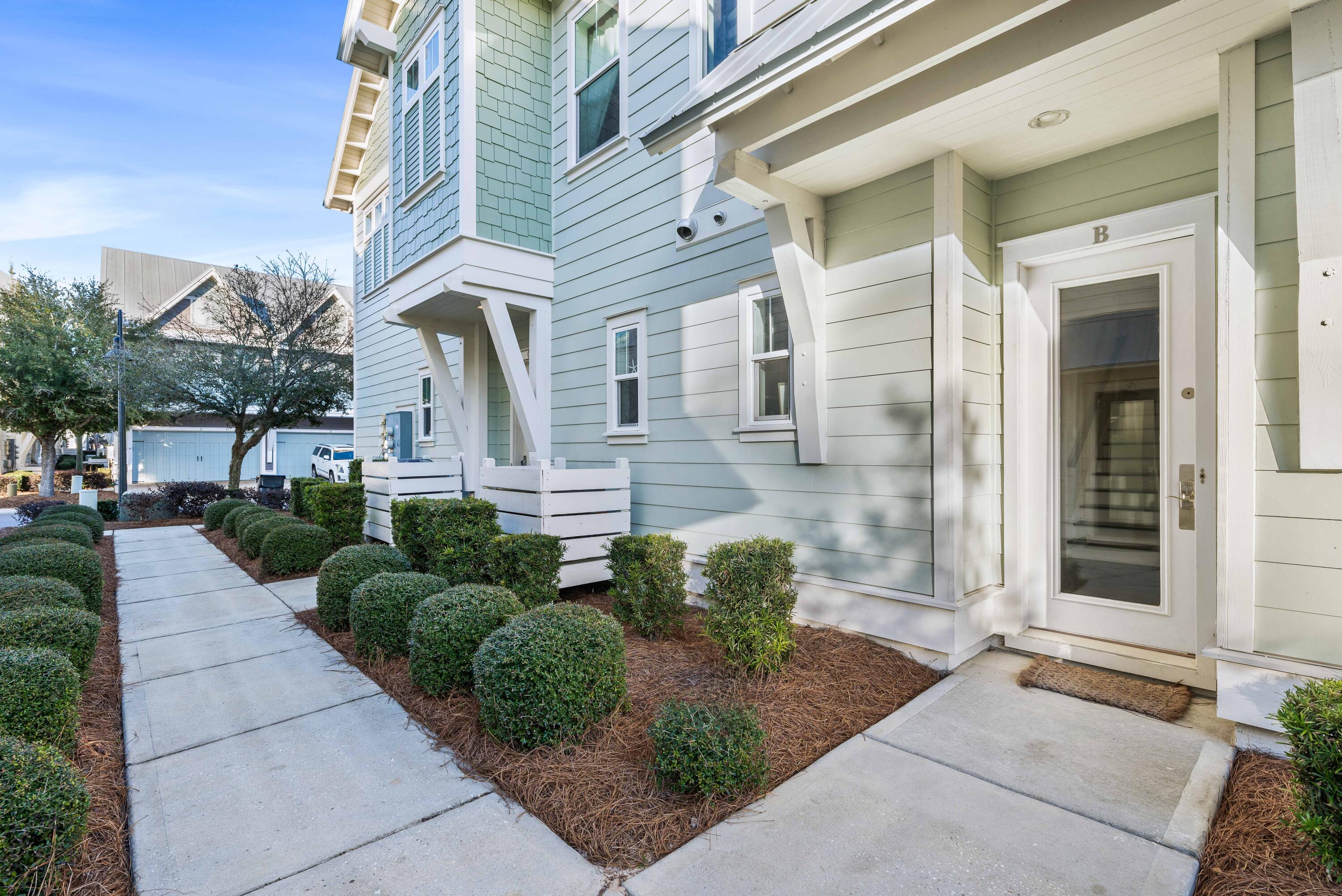 91 Milestone Dr Inlet Beach, Unit B Inlet Beach, FL 32461 - Photo 31 of 51 a front view of a house with garden and plants
