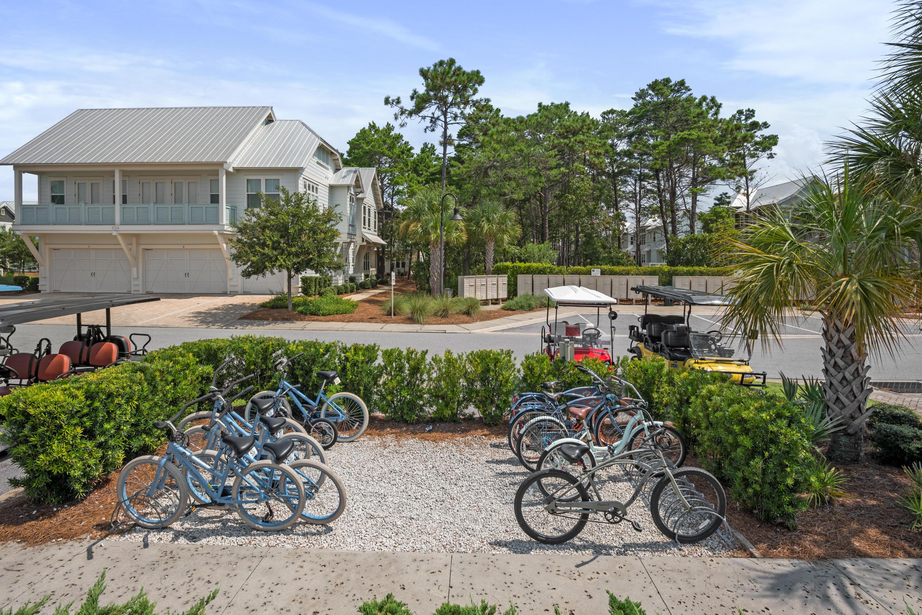 91 Milestone Dr Inlet Beach, Unit B Inlet Beach, FL 32461 - Photo 39 of 51 a view of a backyard with table and chairs potted plants and palm tree