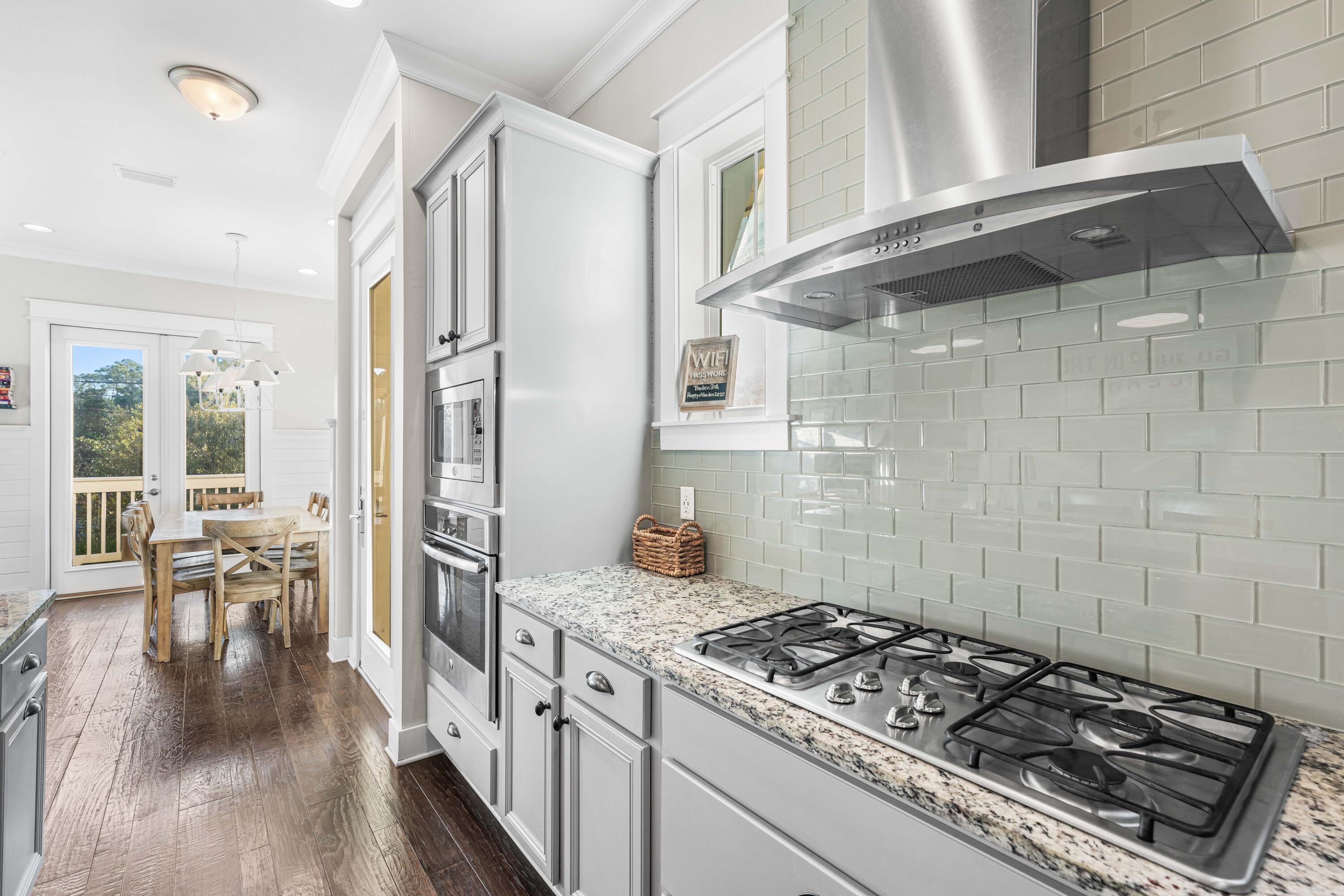 91 Milestone Dr Inlet Beach, Unit B Inlet Beach, FL 32461 - Photo 6 of 51 a kitchen with a stove and wooden floor