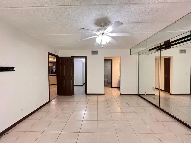 a view of a livingroom with an empty space and a ceiling fan