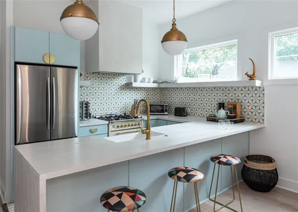 a kitchen with a sink window and cabinets