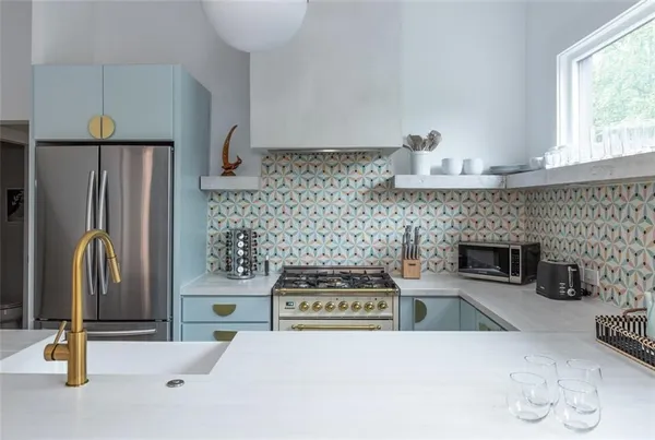 a kitchen with a sink a stove and cabinets