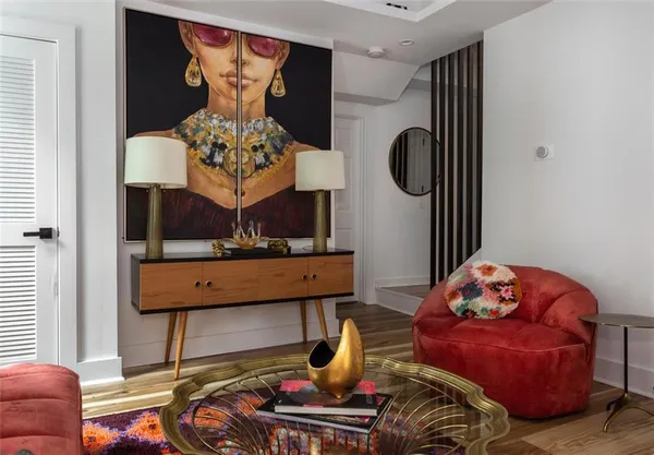 a living room with furniture and a potted plant