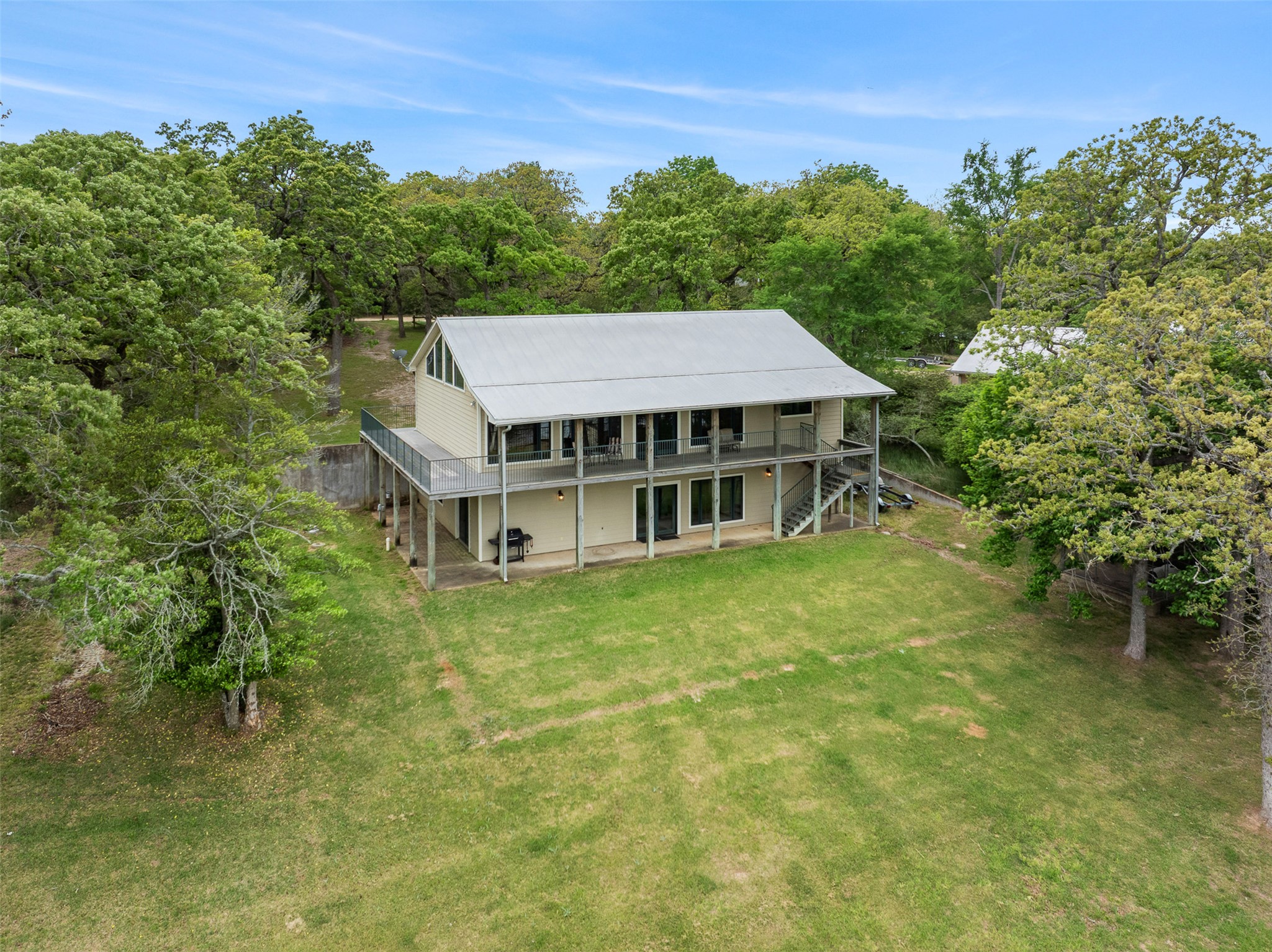 10959 Clyde Acord Road Franklin, TX 77856 - Photo 38 of 39 a aerial view of a house with pool garden and lake view