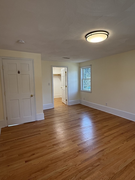 20 Alma Road Burlington, MA 01803 - Photo 15 of 26 an empty room with wooden floor and windows