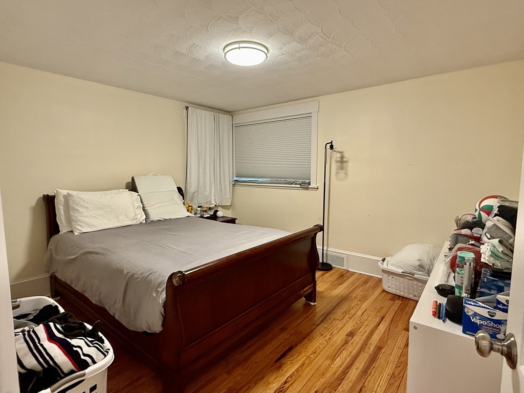 20 Alma Road Burlington, MA 01803 - Photo 8 of 26 a bedroom with a bed and wooden floor