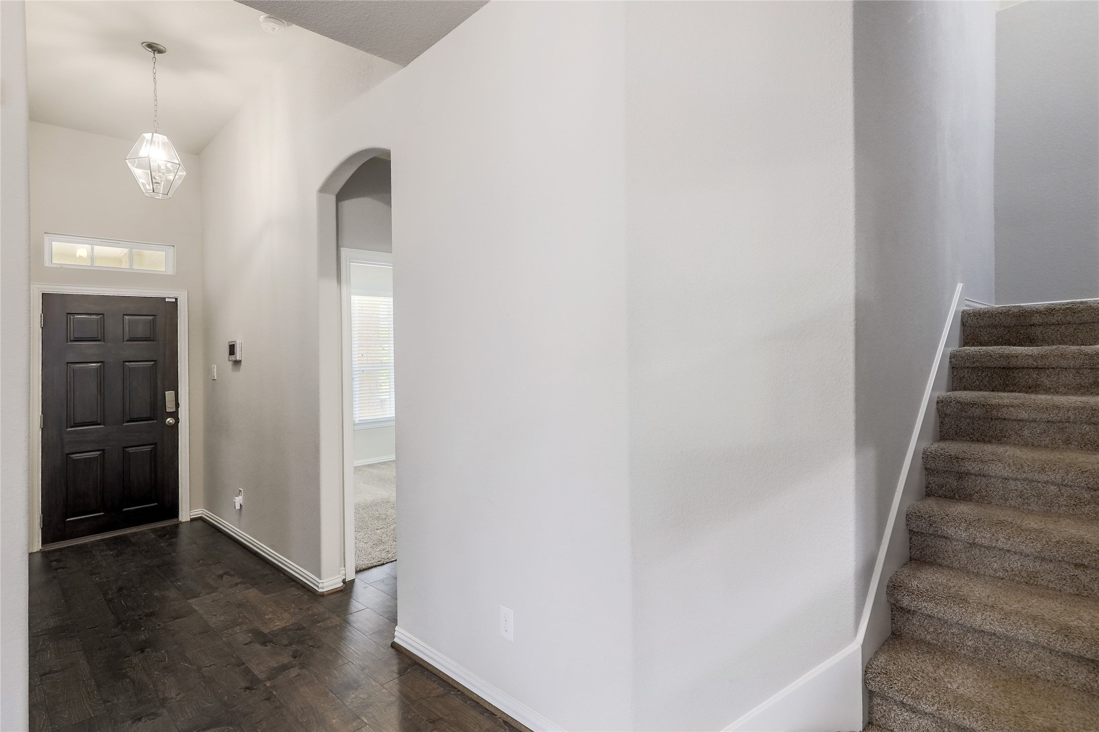 205 Penna Lane Georgetown, TX 78628 - Photo 13 of 32 A well-lit entry hall with rich wood floors and an elegant staircase awaits.