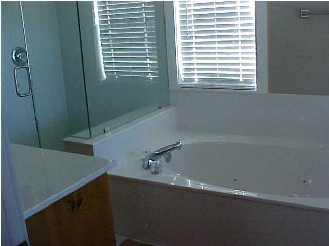 299 Defuniak Street Santa Rosa Beach, FL 32459 - Photo 11 of 16 a bathroom with a bathtub and a shower