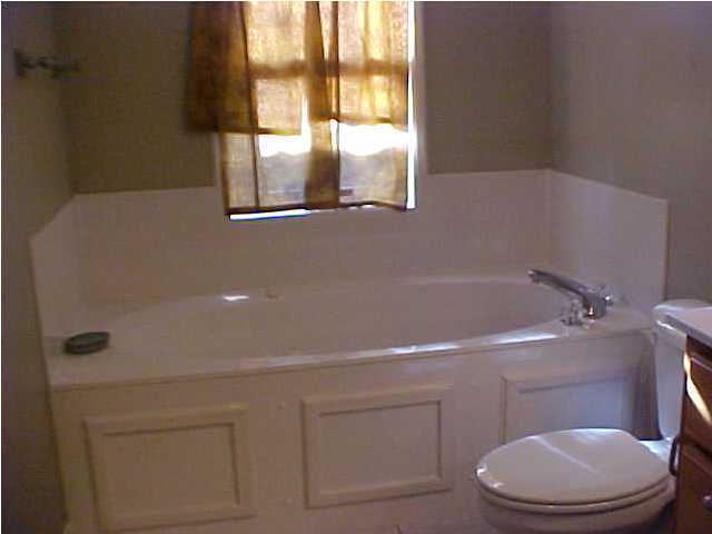 299 Defuniak Street Santa Rosa Beach, FL 32459 - Photo 12 of 16 a bathroom with a toilet and a shower