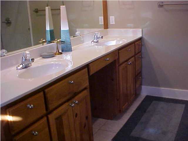 299 Defuniak Street Santa Rosa Beach, FL 32459 - Photo 13 of 16 a bathroom with a double vanity sink and a mirror