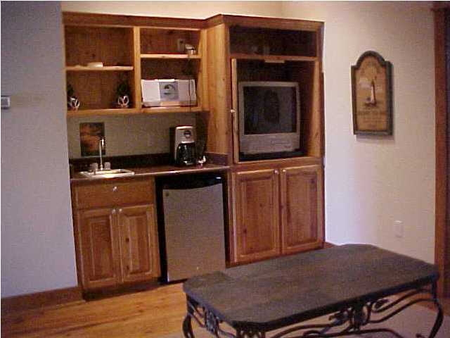 299 Defuniak Street Santa Rosa Beach, FL 32459 - Photo 15 of 16 a workspace with wooden floor and cabinet