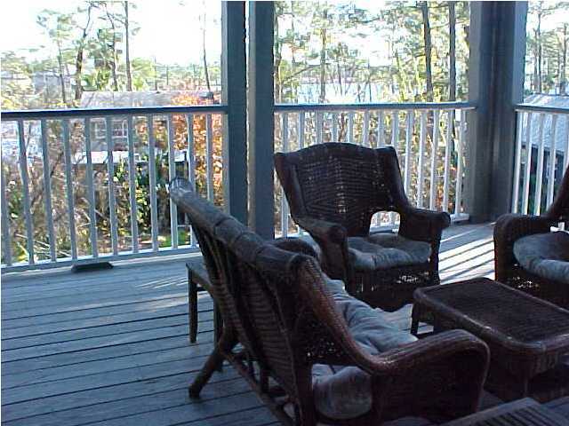 299 Defuniak Street Santa Rosa Beach, FL 32459 - Photo 5 of 16 a living room with furniture and a floor to ceiling window