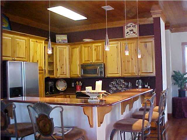 299 Defuniak Street Santa Rosa Beach, FL 32459 - Photo 6 of 16 a kitchen with a sink and a refrigerator