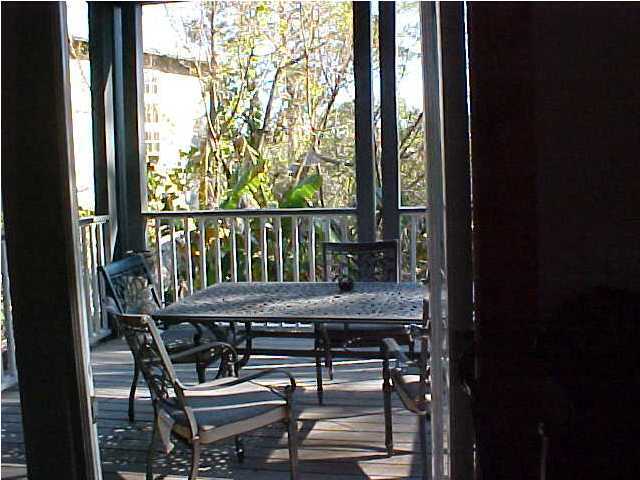 299 Defuniak Street Santa Rosa Beach, FL 32459 - Photo 10 of 16 a view of balcony with wooden floor and outdoor seating