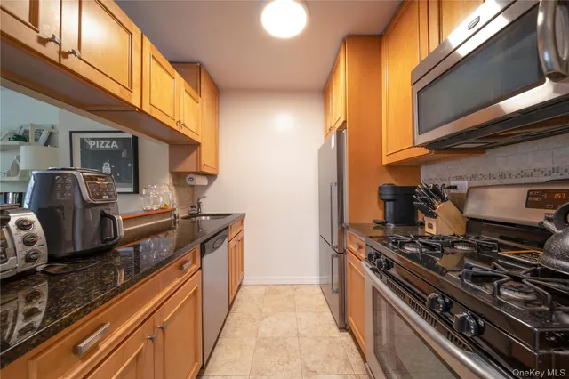 a kitchen with stainless steel appliances granite countertop a stove and a sink