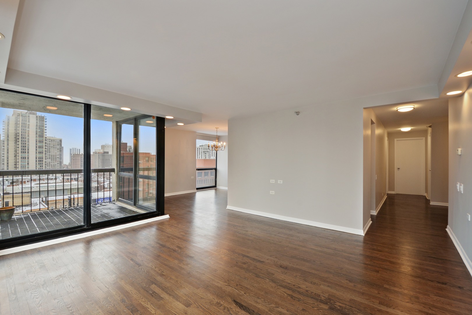 1122 North Clark Street, Unit 1203 Chicago, IL 60610 - Photo 4 of 22 a view of an empty room with wooden floor and a window
