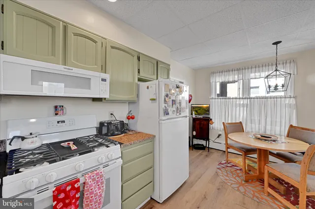 a kitchen with stainless steel appliances granite countertop a stove and a refrigerator