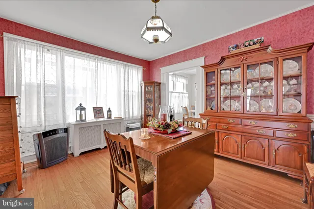 a view of a dining room with furniture a chandelier and wooden floor