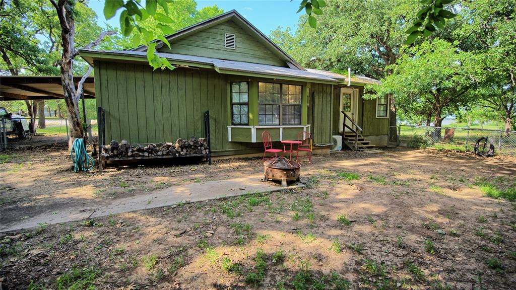 140 Elm Road Nocona, TX 76255 - Photo 2 of 26 a view of a house with backyard and sitting area