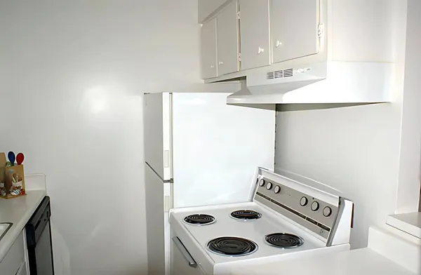 a kitchen with a refrigerator and a stove