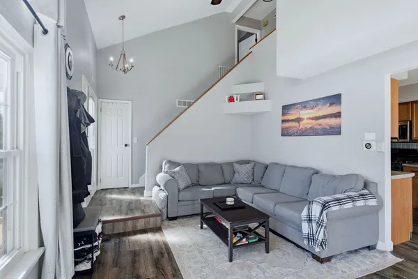 a living room with furniture and a chandelier