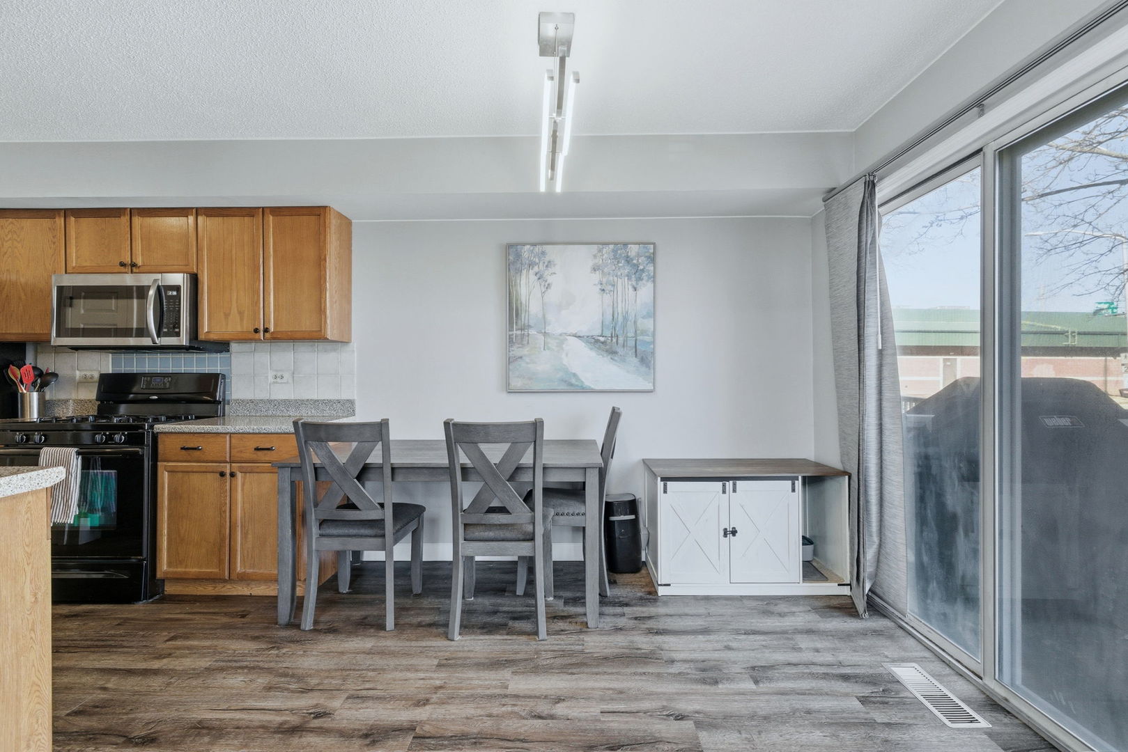 345 Redwing Drive Bolingbrook, IL 60440 - Photo 5 of 16 a kitchen with stainless steel appliances granite countertop a stove top oven a sink and a microwave