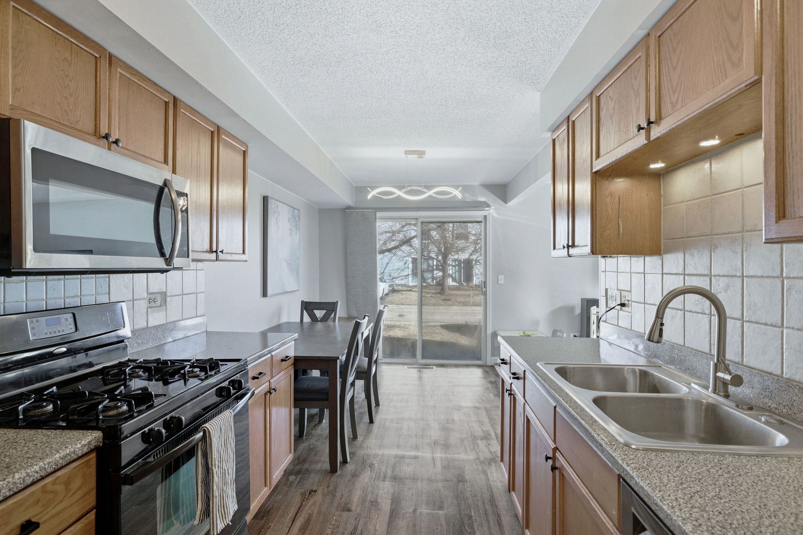 345 Redwing Drive Bolingbrook, IL 60440 - Photo 7 of 16 a kitchen with granite countertop a sink stove and refrigerator
