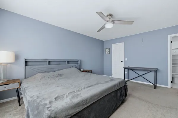 a bedroom with a bed a desk and chair