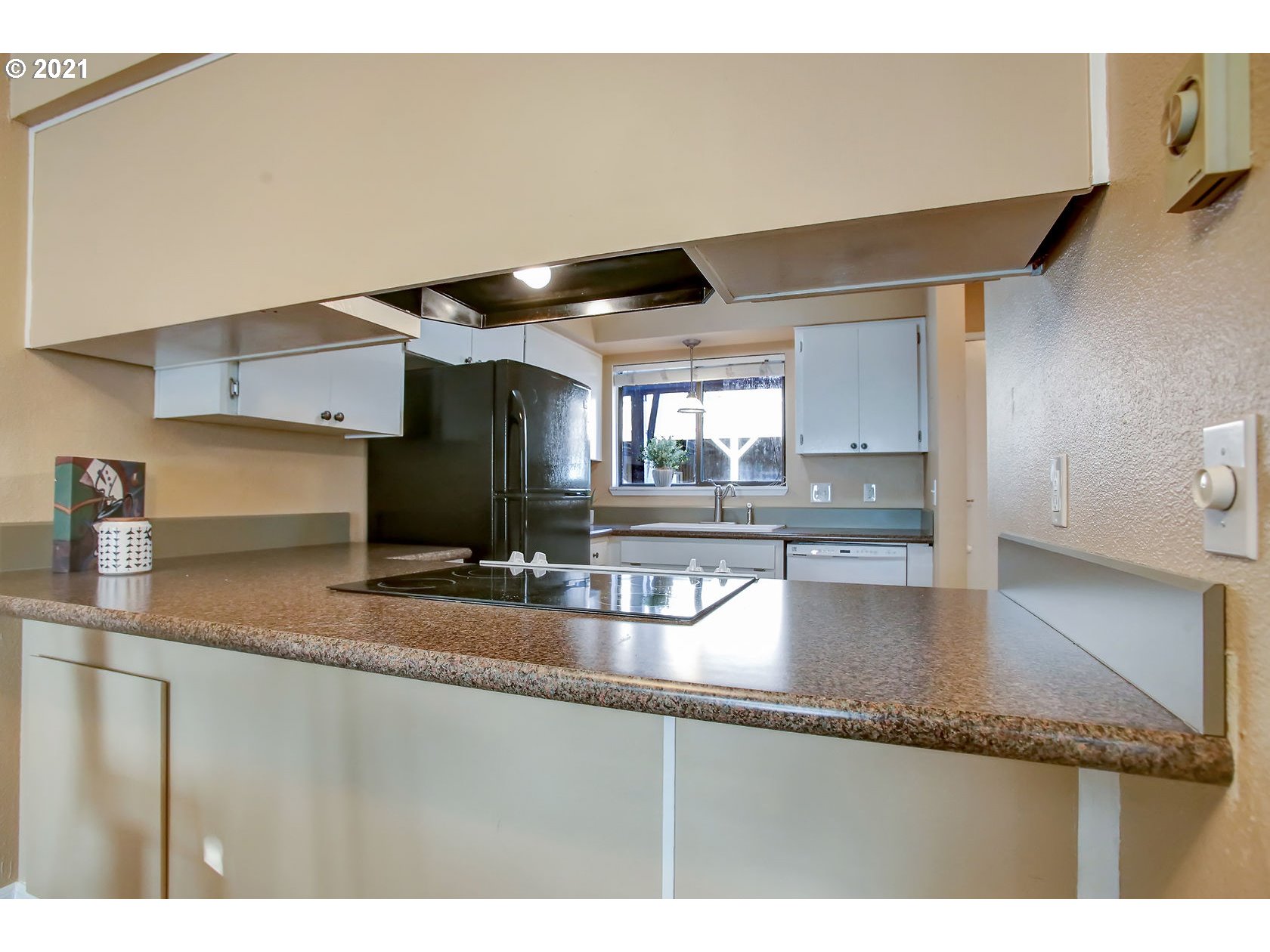 10237 Southwest Denney Road Beaverton, OR 97008 - Photo 16 of 32 a kitchen with granite countertop a sink and a stove top oven