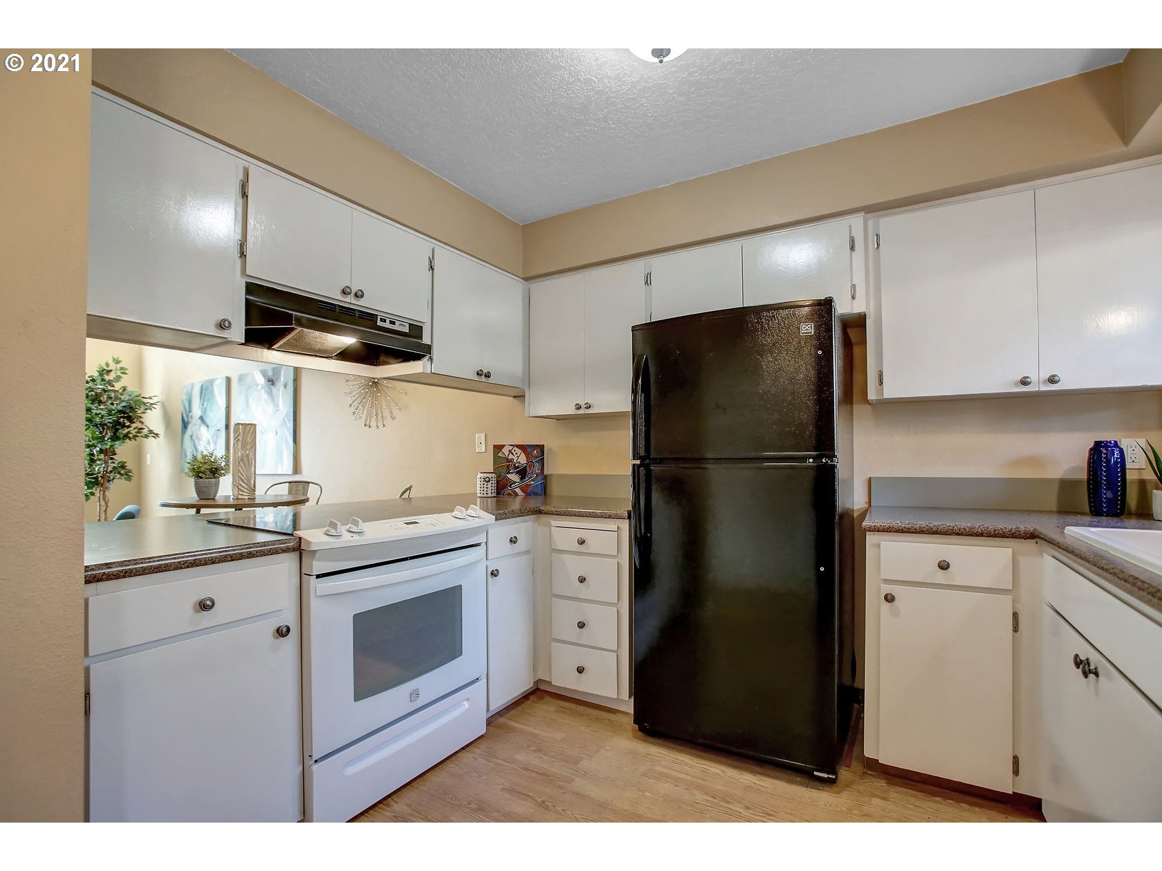 10237 Southwest Denney Road Beaverton, OR 97008 - Photo 17 of 32 a kitchen with stainless steel appliances a refrigerator sink and cabinets