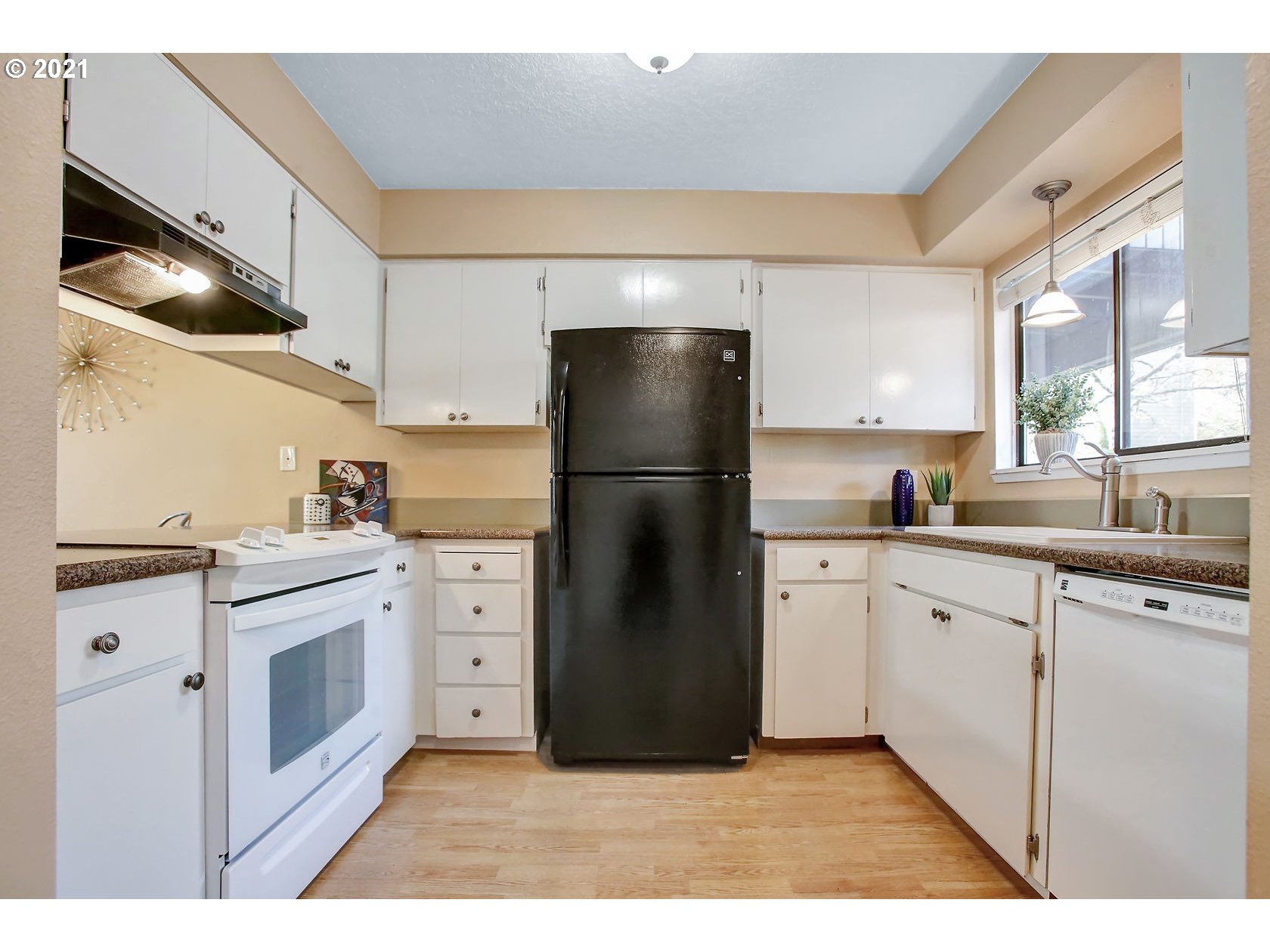 10237 Southwest Denney Road Beaverton, OR 97008 - Photo 18 of 32 a kitchen with a refrigerator and a sink