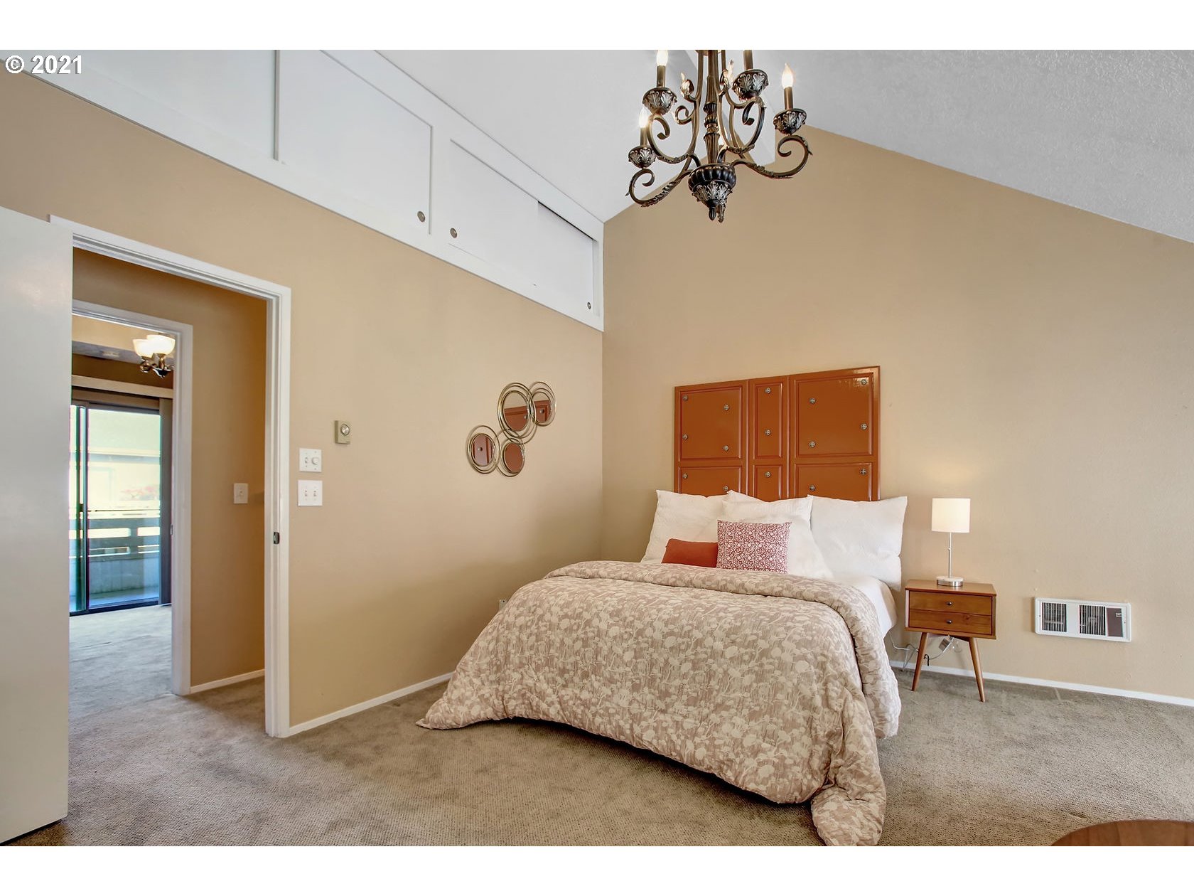 10237 Southwest Denney Road Beaverton, OR 97008 - Photo 22 of 32 a bedroom with a bed and a chandelier