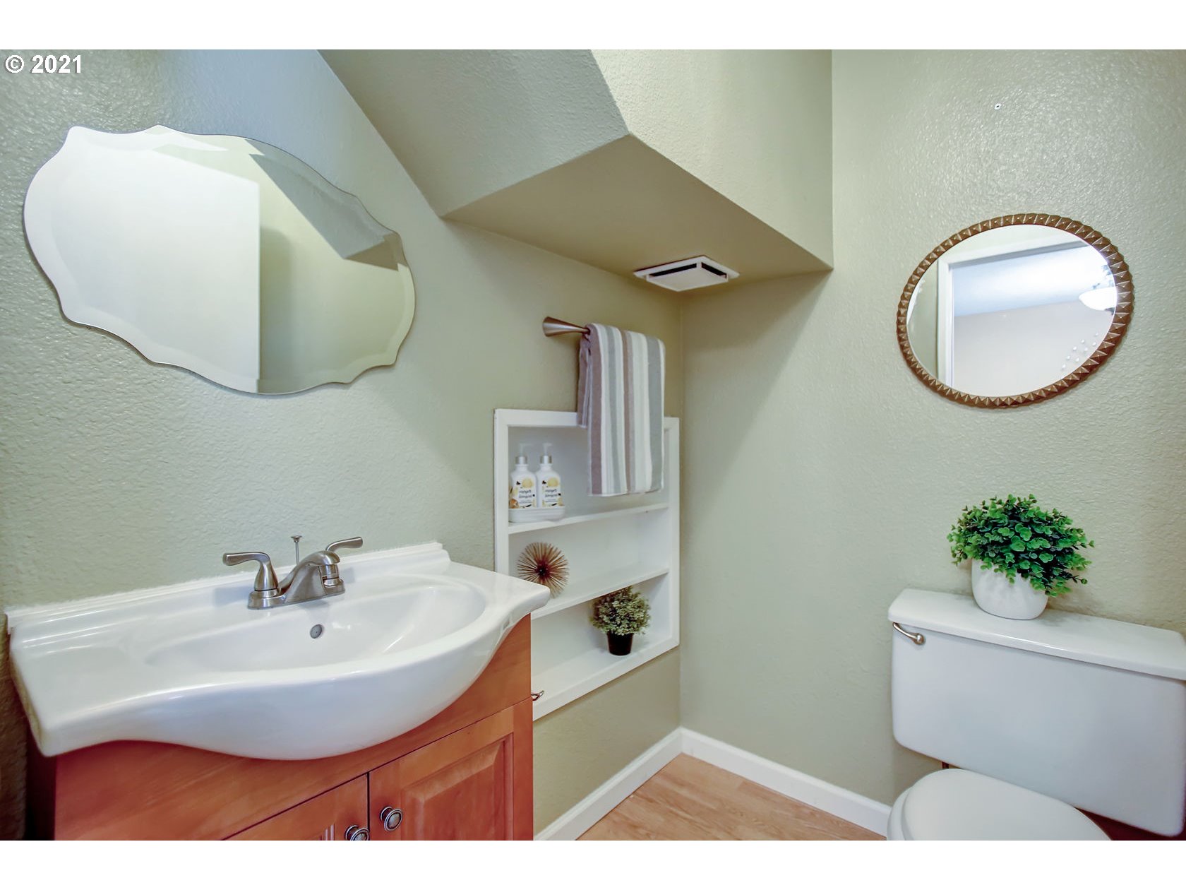 10237 Southwest Denney Road Beaverton, OR 97008 - Photo 25 of 32 a bathroom with a sink a mirror and a toilet