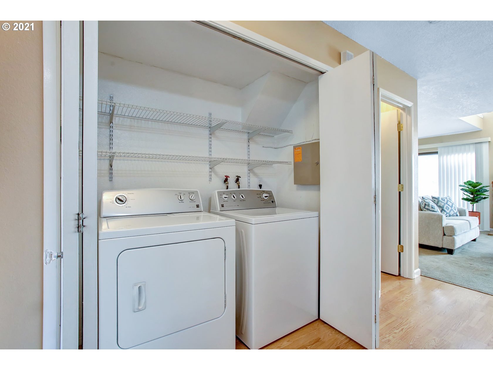 10237 Southwest Denney Road Beaverton, OR 97008 - Photo 26 of 32 a view of washer and dryer with kitchen in the background