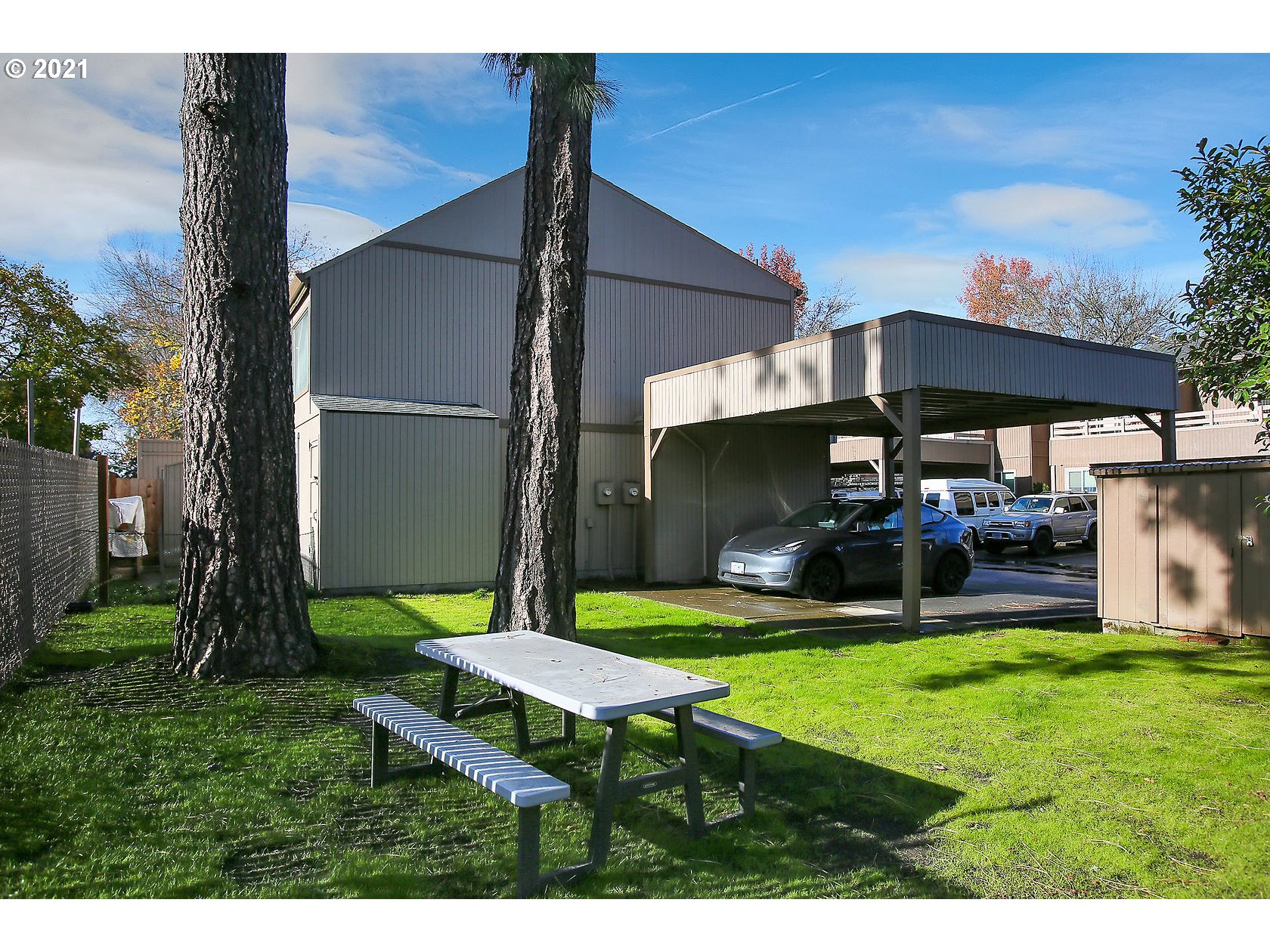 10237 Southwest Denney Road Beaverton, OR 97008 - Photo 31 of 32 a view of a backyard with table and chairs under an umbrella