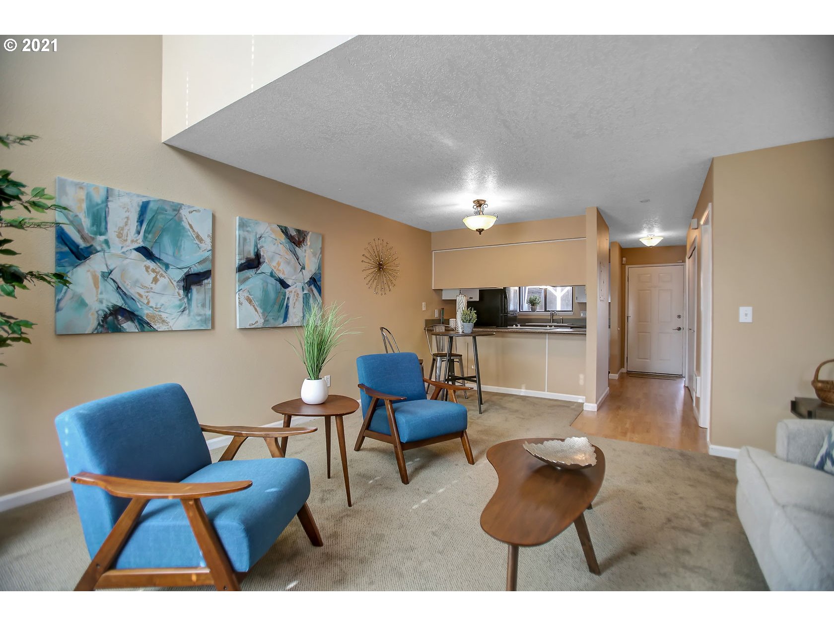 10237 Southwest Denney Road Beaverton, OR 97008 - Photo 10 of 32 a living room with furniture and kitchen view