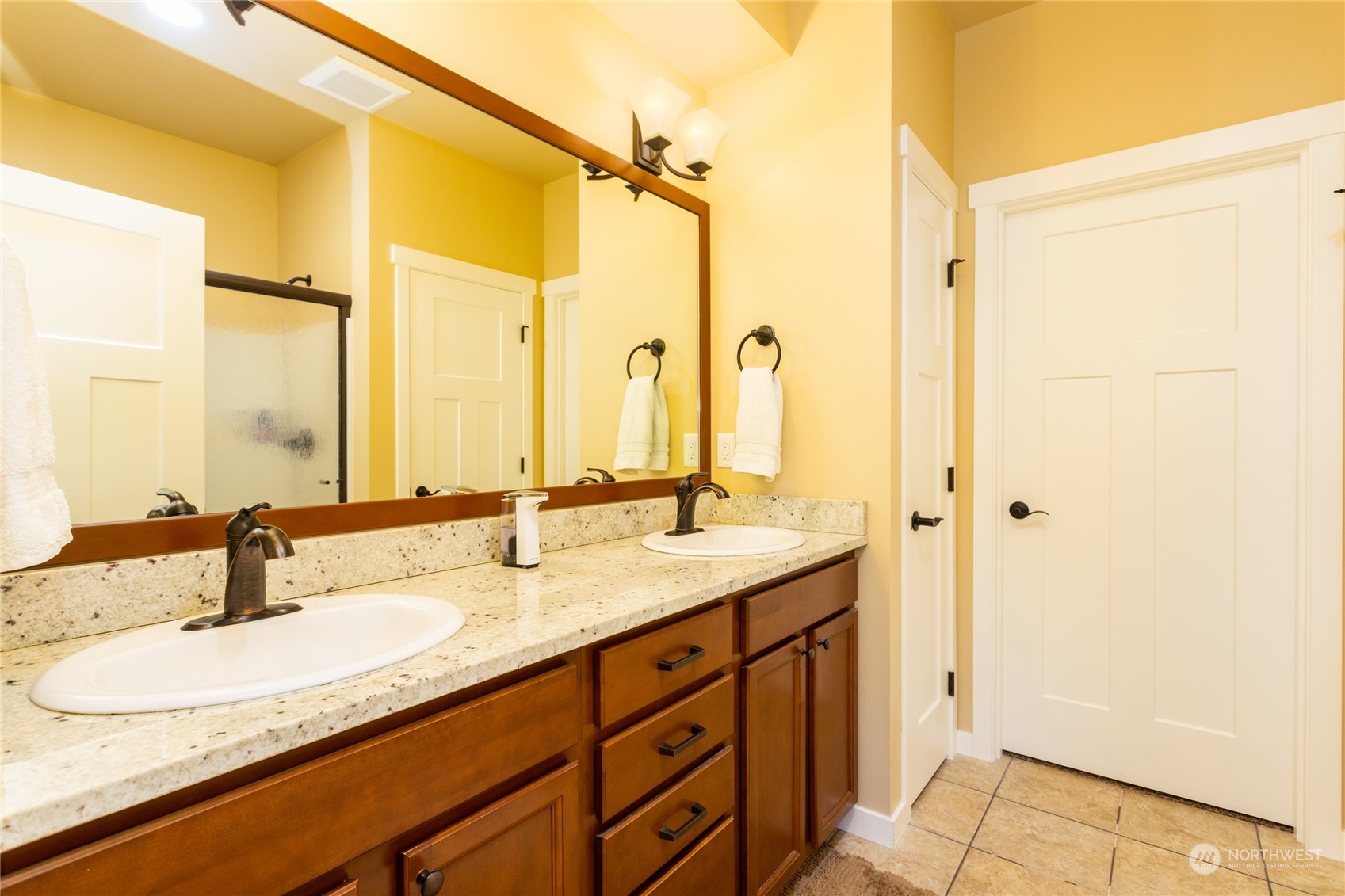 1563 Bryce Park Loop Lynden, WA 98264 - Photo 18 of 32 a bathroom with a granite countertop sink and a mirror