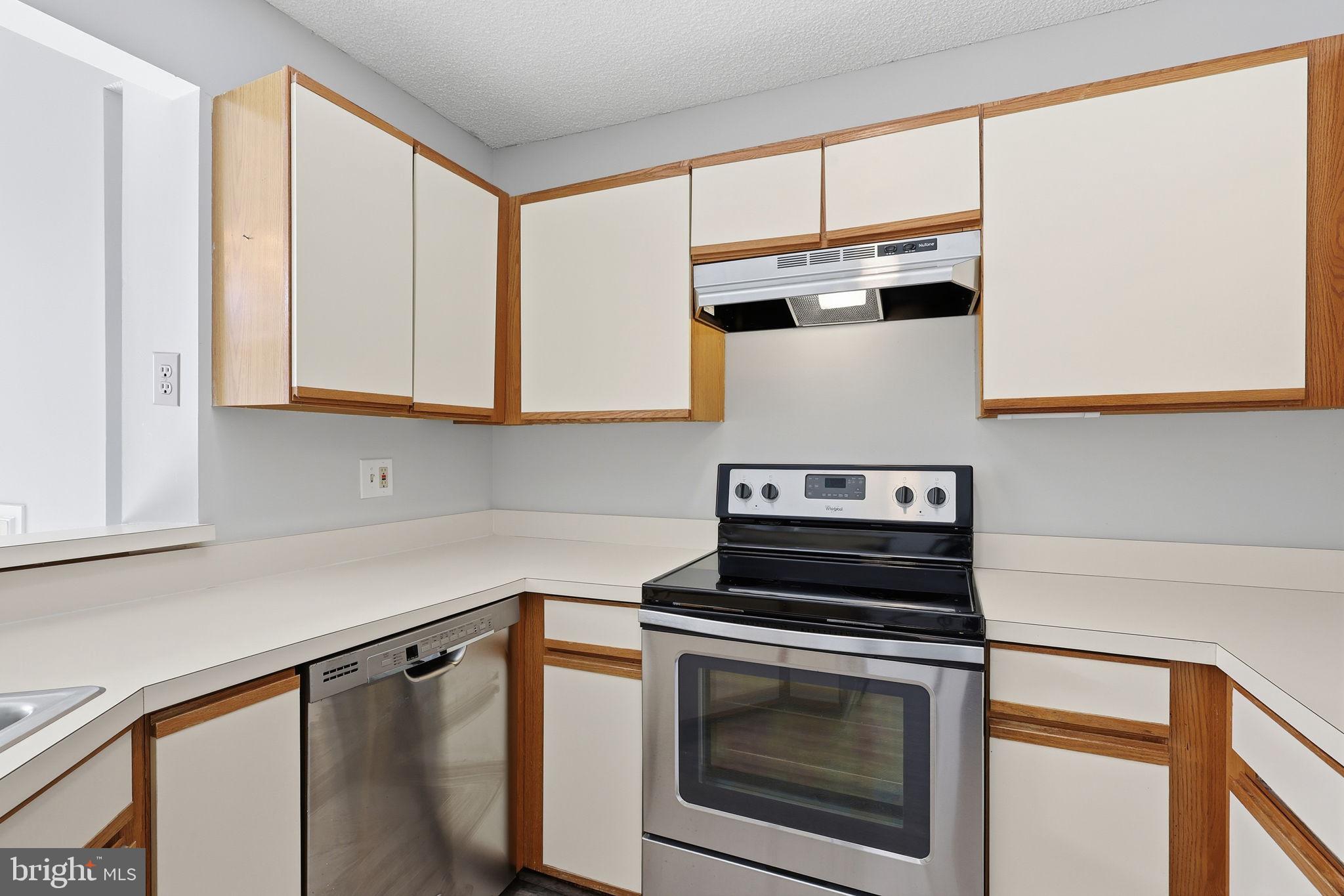 1508 Summerchase Court Reston, VA 20194 - Photo 11 of 23 a kitchen with stainless steel appliances a stove a microwave and cabinets