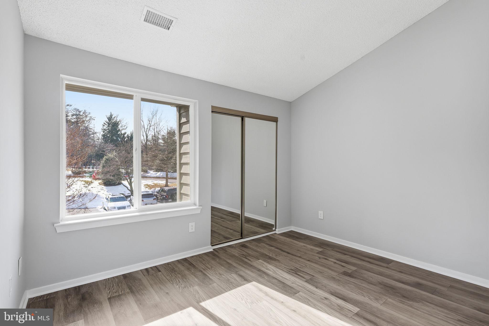 1508 Summerchase Court Reston, VA 20194 - Photo 15 of 23 an empty room with wooden floor and windows
