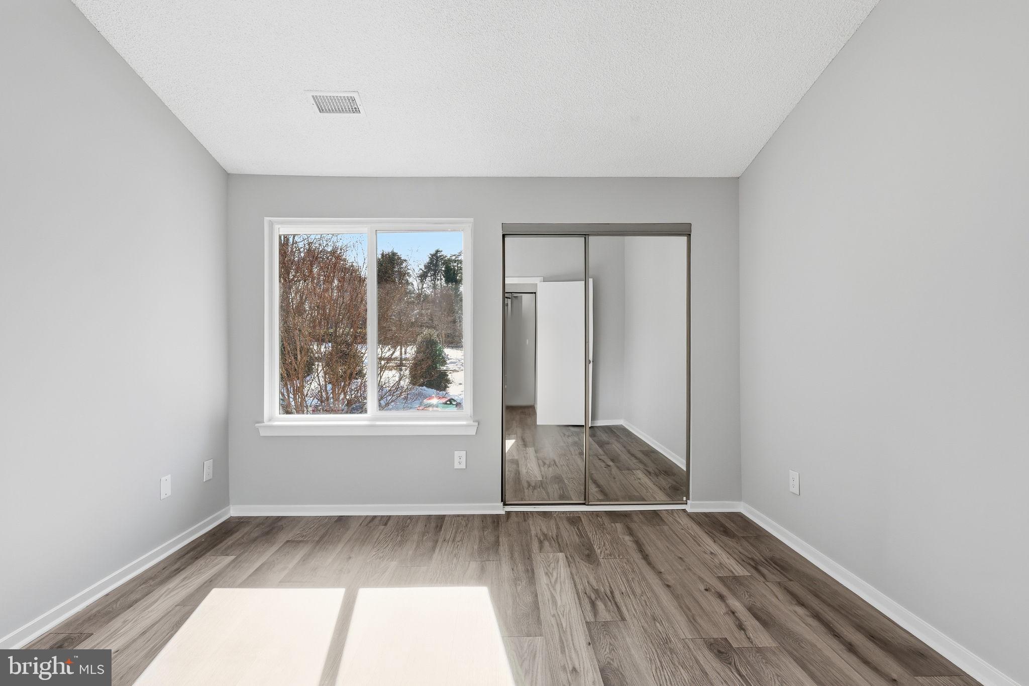 1508 Summerchase Court Reston, VA 20194 - Photo 18 of 23 an empty room with wooden floor and windows