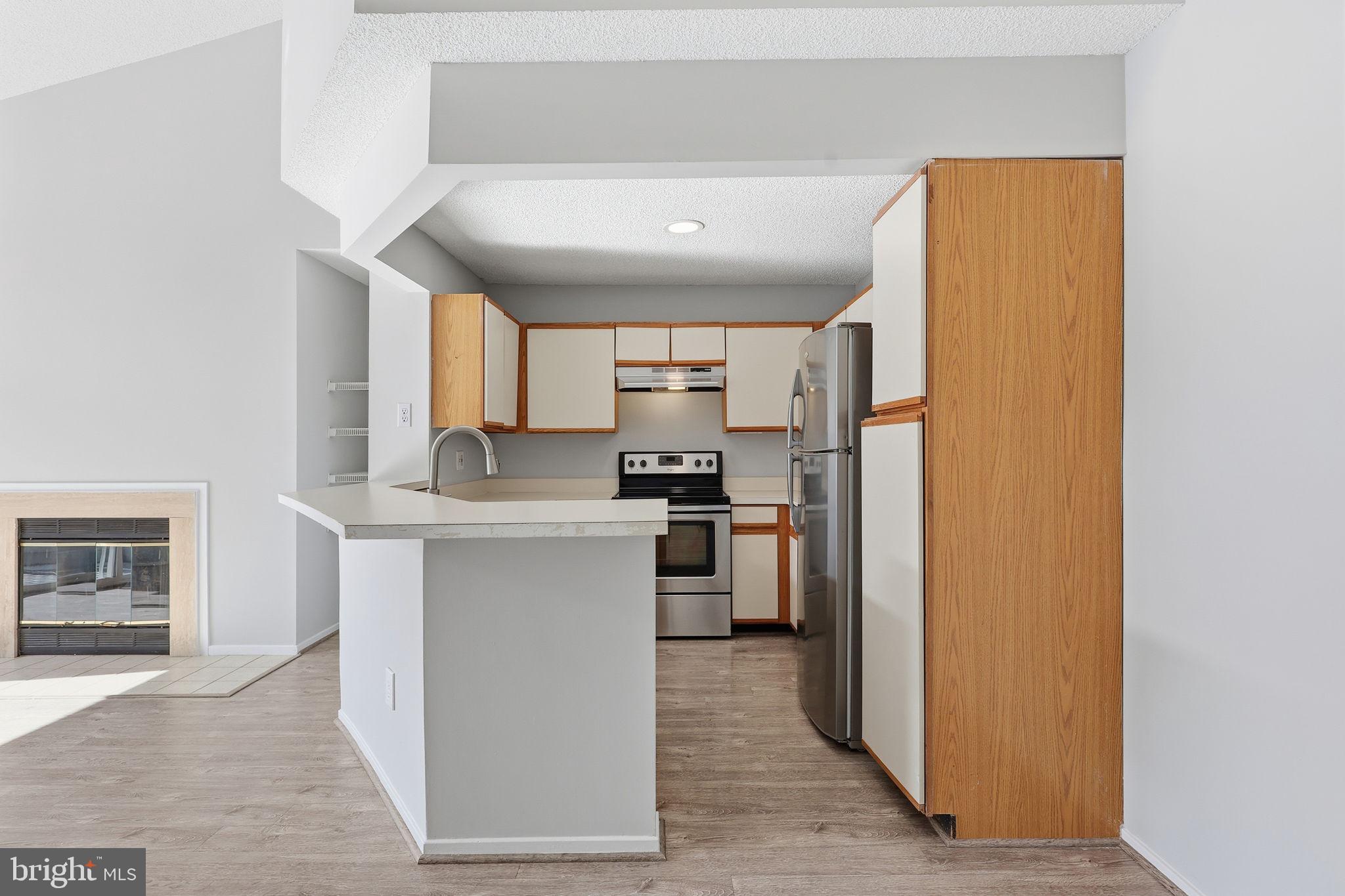 1508 Summerchase Court Reston, VA 20194 - Photo 8 of 23 a kitchen with a refrigerator and a stove top oven