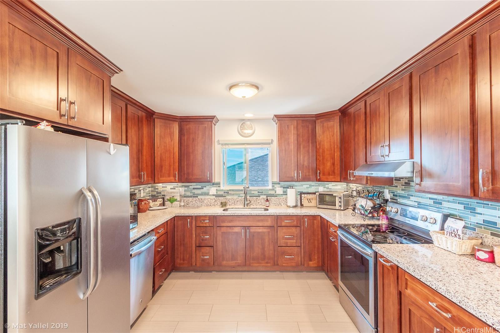 2932 Numana Road Honolulu, HI 96819 - Photo 1 of 1 a kitchen with a sink refrigerator and cabinets
