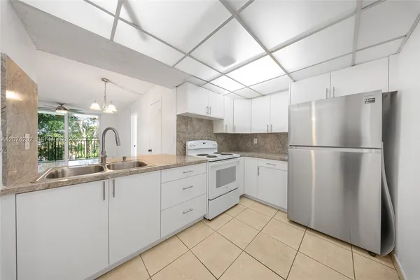 a kitchen with white cabinets and white appliances