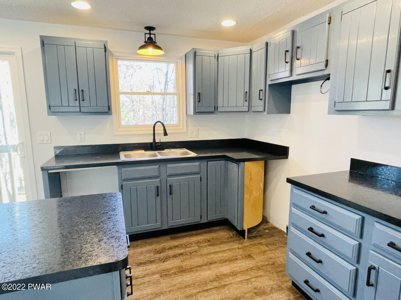 197 Gold Key Road Milford, PA 18337 - Photo 8 of 34 a kitchen with stainless steel appliances granite countertop a sink stove and cabinets