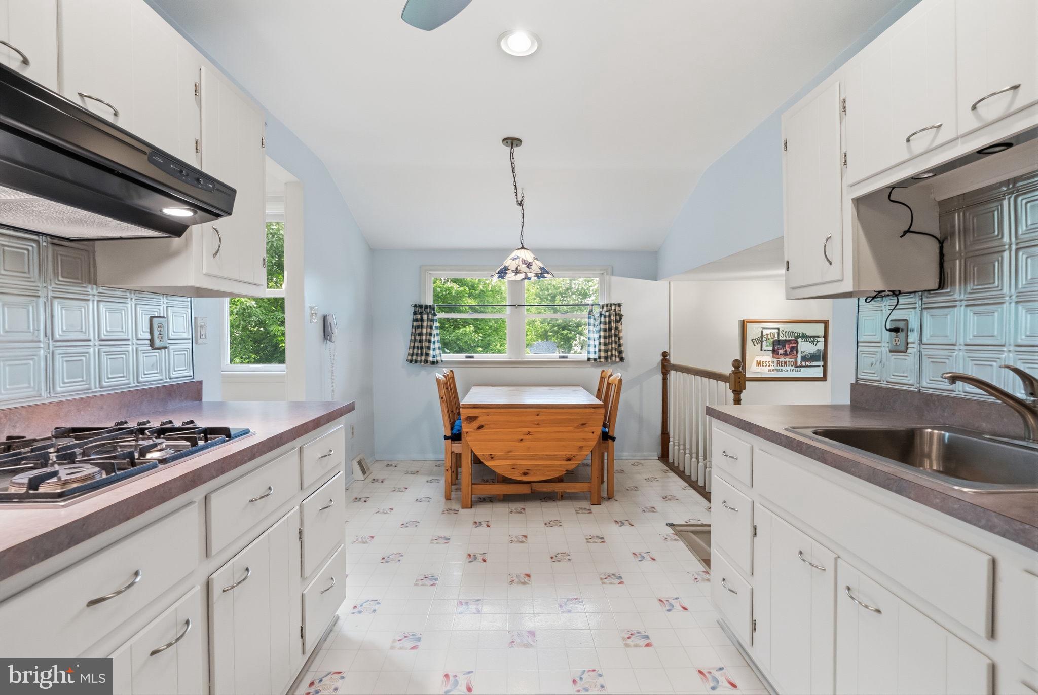 81 Cherokee Road Doylestown, PA 18901 - Photo 7 of 43 a kitchen with stainless steel appliances kitchen island a stove a sink and a refrigerator