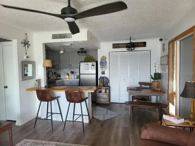 a view of kitchen and dining area with granite countertop wooden floor