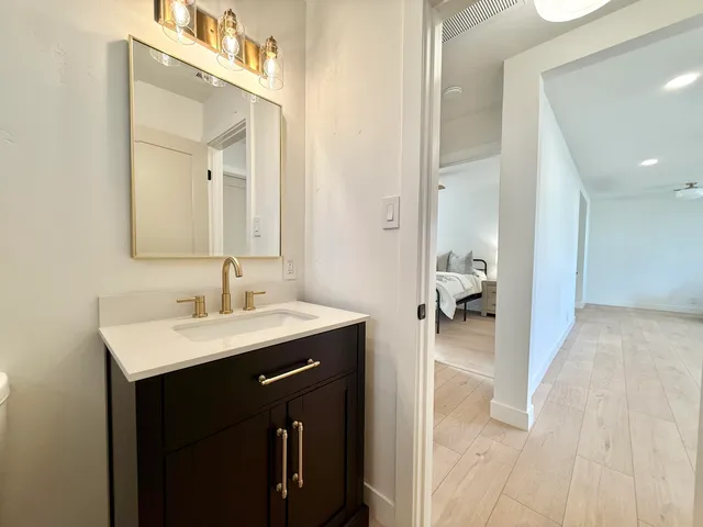 a white house with a big yard and large trees